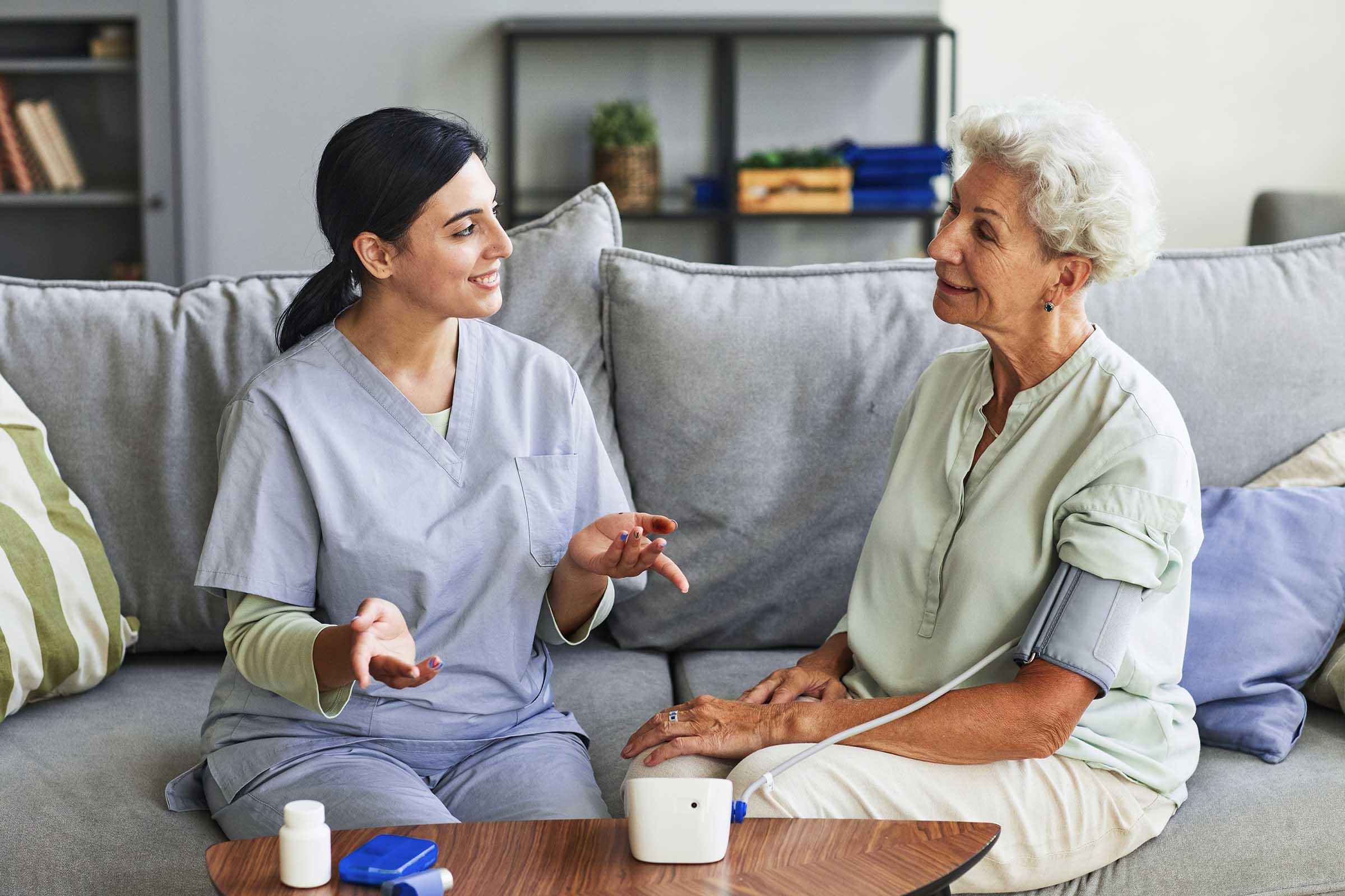 young-nurse-talking-to-senior-woman-in-retirement-AL8CX4V.jpg